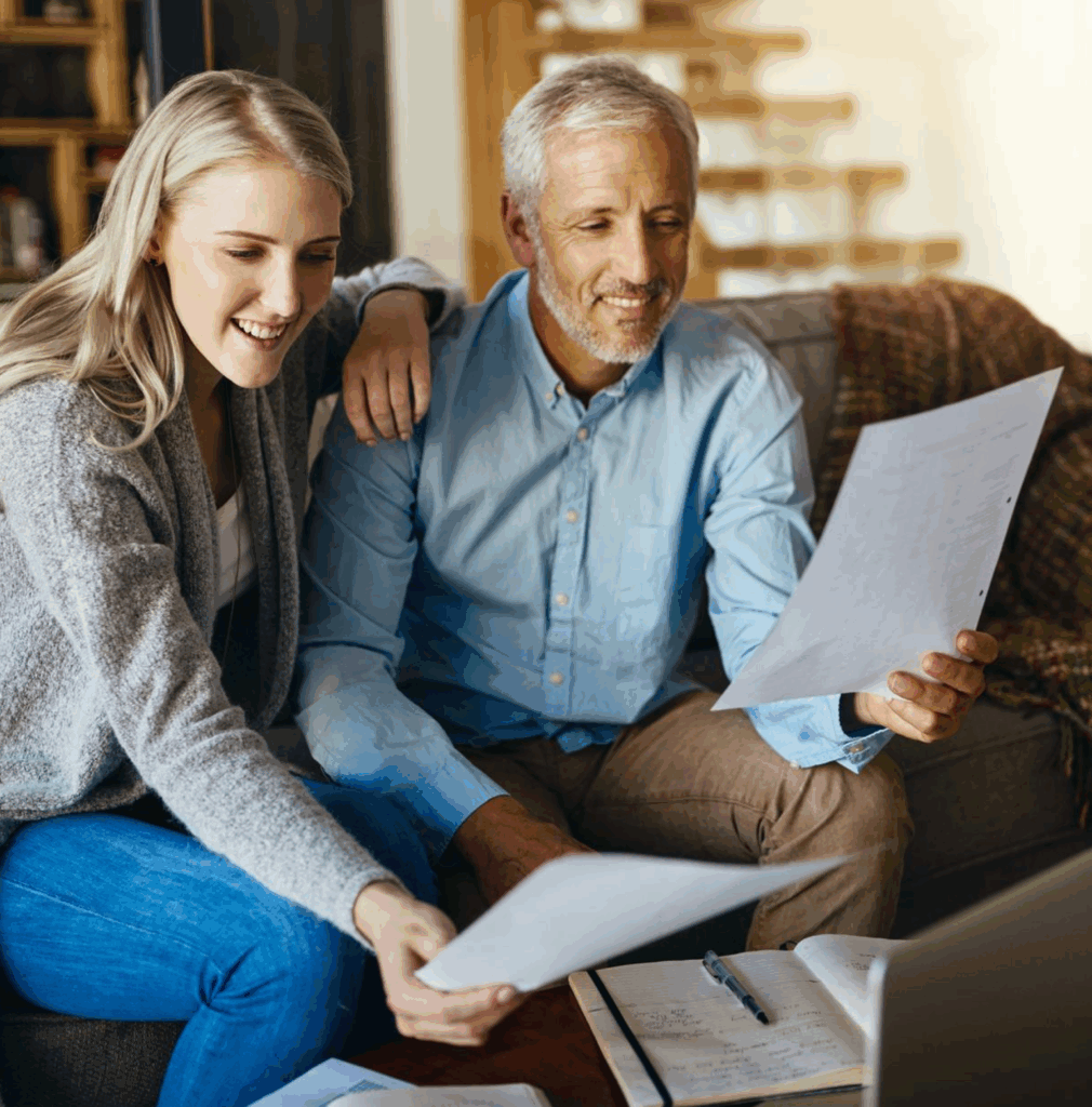 Relieved couple reviewing Chapter 7 bankruptcy plan with Gadsden AL bankruptcy lawyer