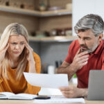 Concerned couple reviewing debt before contacting a bankruptcy attorney in Anniston AL