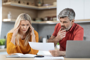 Concerned couple reviewing debt before contacting a bankruptcy attorney in Anniston AL