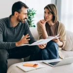 Couple discussing finances highlighting debt impact on relationships and well-being - Northeast Alabama